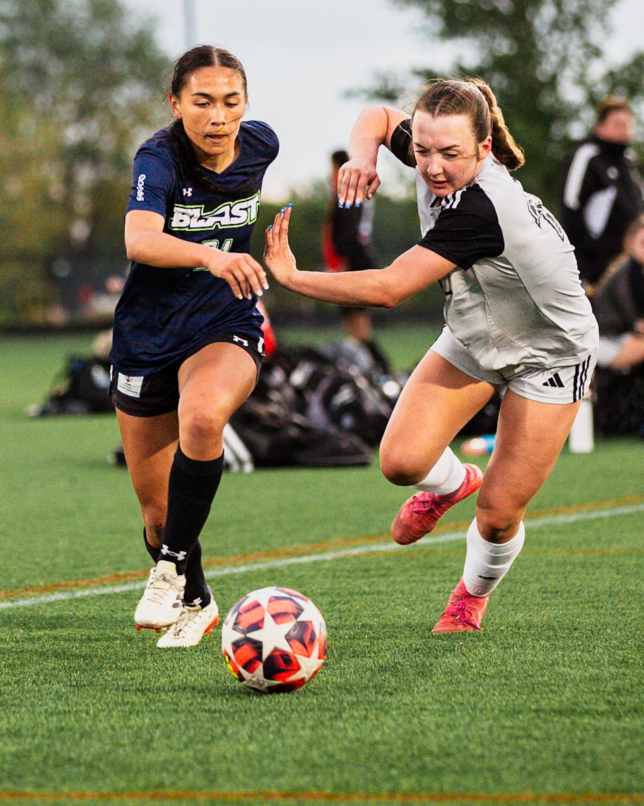 Youth soccer action on a green pitch